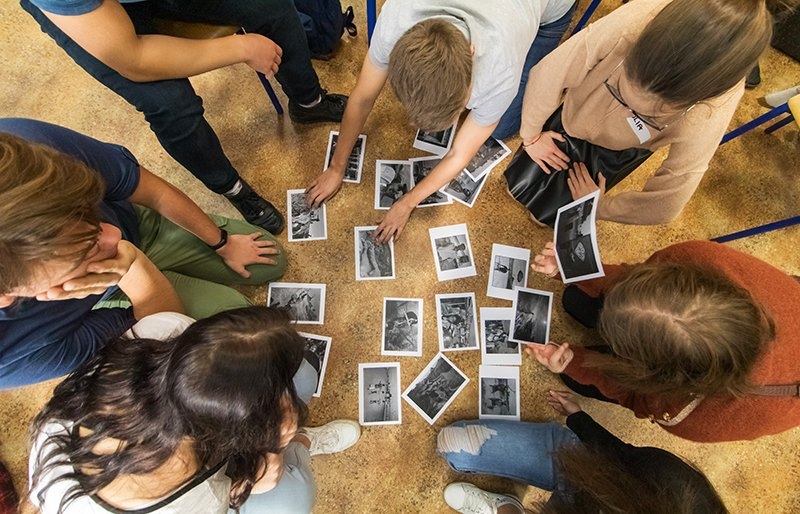 Group of young people sorting photos